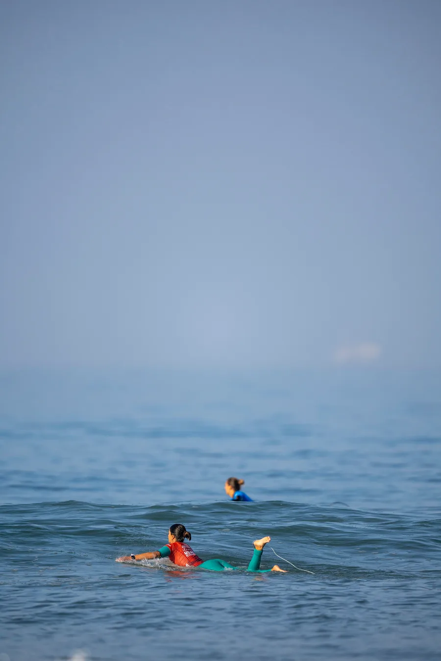 Two surfers waiting in the lineup for the next wave